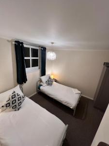 a bedroom with two beds and a chandelier at Whole Flat - Free Parking - Cathedral & Canal View in Lincoln +12 photos