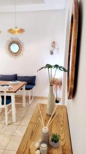 a living room with a table and a vase at Dar Houta Hammamet Mrezga in Nabeul