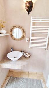 a bathroom with a white sink and a mirror at Dar Houta Hammamet Mrezga in Nabeul +29 photos