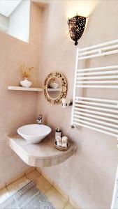 a bathroom with a sink and a mirror at Dar Houta Hammamet Mrezga in Nabeul
