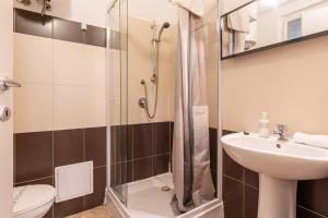 a bathroom with a shower and a sink and a toilet at EcoStay Apartment by the Basilica in Budapest +12 photos