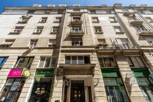 a tall stone building with windows and a door at EcoStay Apartment by the Basilica in Budapest