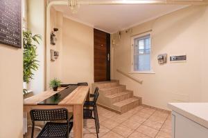 a dining room with a table and chairs and stairs at EcoStay Apartment by the Basilica in Budapest