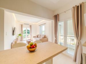 a room with a table with a bowl of fruit on it at Terra Residence in Ágios Rókkos