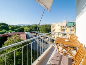 a balcony with a wooden table and chairs at Terra Residence in Ágios Rókkos