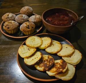 a table with two bowls of muffins and a plate of food at St. Peterburg in Pärnu
