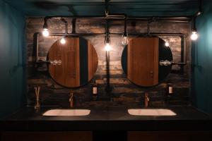 a bathroom with two sinks and two mirrors at Samzeo Tusheti in Omalo +43 photos