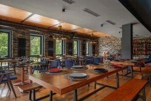 a dining room with wooden tables and chairs at Samzeo Tusheti in Omalo
