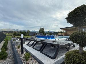 a picnic table sitting next to a swimming pool at Górska Grań in Poronin