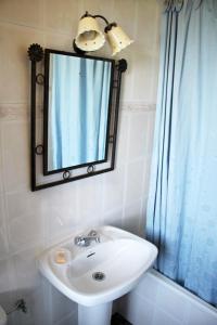 a bathroom with a sink and a mirror at Casa de Aldea El Valle in Buelna +60 photos