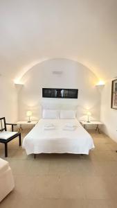 A bed or beds in a room at Masseria Frassaniti