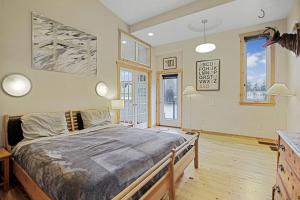 1 dormitorio con 1 cama grande y algunas ventanas en Peaceful Waterfront Escape In Skamokawa, en Skamokawa