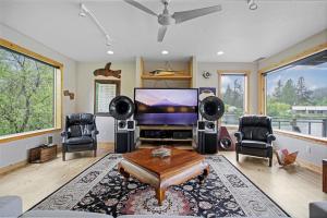 Una sala de estar con televisión, mesa y sillas. en Peaceful Waterfront Escape In Skamokawa, en Skamokawa