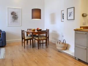 a kitchen and dining room with a table and chairs at Printmakers Cottage in Bellanoch +16 photos