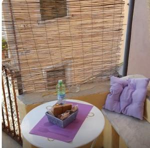 a table with a bottle and a basket on a table at La Stanzetta Viola in Fezzano