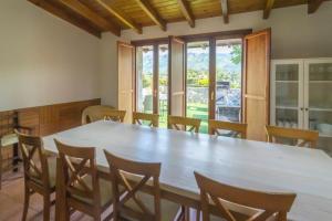 a dining room with a large wooden table and chairs at Villa Porrua 2 in Porrúa