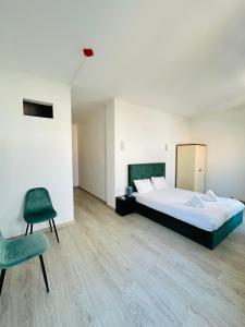 a bedroom with a large bed and a chair at Residencial Pimenta ,Portimao,Algarve in Portimão