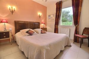 a bedroom with a bed with two pillows and a window at Les jardins de kerarzic in Ploubazlanec