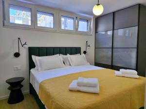 a bedroom with a large bed with two towels on it at Apartment MM in Omiš