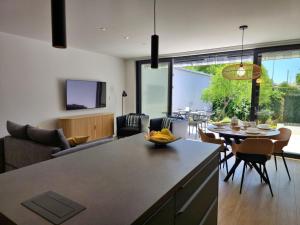 a kitchen and living room with a table and chairs at Apartment MM in Omiš