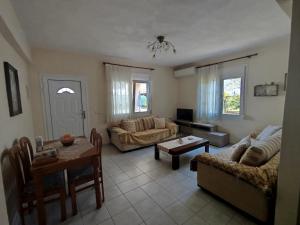 a living room with a couch and a table at Accommodation Lydia in Leptokarya