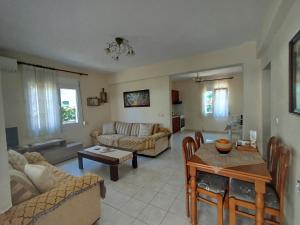 a living room with a couch and a table at Accommodation Lydia in Leptokarya
