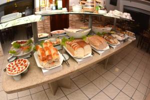 a table filled with lots of different types of food at FLAT HShotelaria in Florianópolis +15 photos