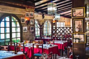 a restaurant with tables with red table cloth at Rihana Hotel - Ain Draham in Aïn Draham