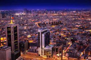 an aerial view of a city at night at Downtown Rotana in Manama