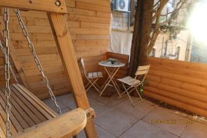 a porch with a chair and a table with at אחוזת ישוב הדעת in Safed +4 photos