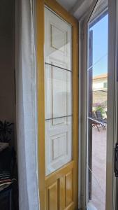 a door with a white curtain and a window at Etna Docet in Nicolosi