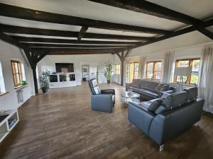 a large living room with couches and a table at Über dem Kattsund in Eckernförde