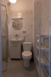 Un baño blanco con inodoro y lavabo. en Central flat at plac Konstytucji, en Varsovia