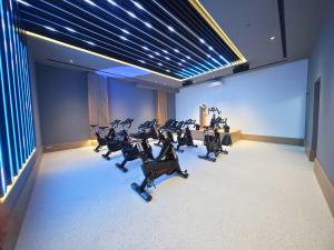 a gym with several treadmills in a room at Hipotels Barrosa Garden in Chiclana de la Frontera
