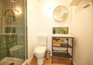 a bathroom with a toilet and a glass shower at La Quinta Bordeaux-Bègles in Bègles