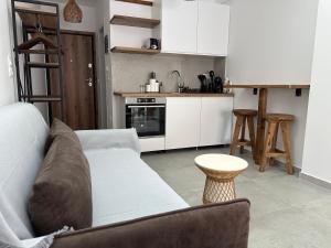 a living room with a couch and a kitchen at VMJ side sea view in Perea