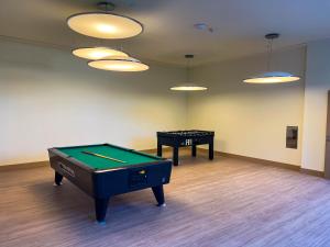 a room with a ping pong table and a game table at Hipotels Barrosa Garden in Chiclana de la Frontera