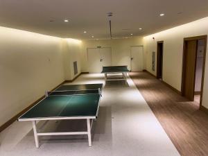 a room with two ping pong tables in it at Hipotels Barrosa Garden in Chiclana de la Frontera