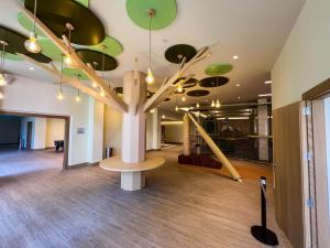 a large room with a tree on the ceiling at Hipotels Barrosa Garden in Chiclana de la Frontera