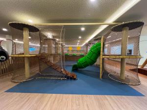 a childrens play room with a slide and a climbing gym at Hipotels Barrosa Garden in Chiclana de la Frontera