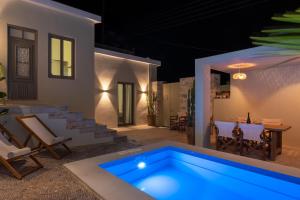 a villa with a swimming pool at night at Gioma Luxury Villas in Agios Nikolaos