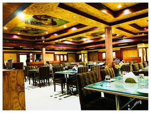 a dining room with tables and chairs in a restaurant at Grand Residency Cuttack in Cuttack +52 photos