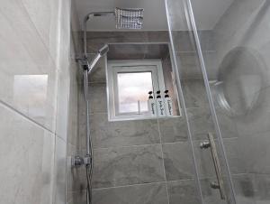 a bathroom with a shower with a window at Private & Relaxed Apartments 1-5 in Cardiff +35 photos
