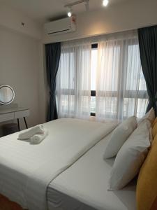 Ένα ή περισσότερα κρεβάτια σε δωμάτιο στο Agile KLCC Suites By TRX