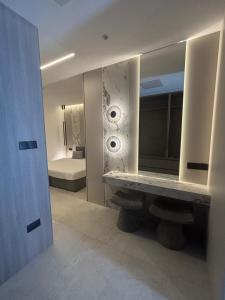 a bathroom with a mirror and a sink in a room at Tuck Inn in Larnaca