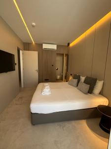 a bedroom with a large white bed in a room at Tuck Inn in Larnaca