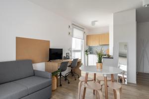 a living room with a couch and a table at Apartamenty Depot Gdańsk in Gdańsk