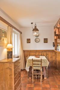 a dining room with a table and a chandelier at Chesa Michela - Champfer in Champfer +16 photos