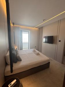 a bedroom with a large bed with a mirror at Tuck Inn in Larnaca