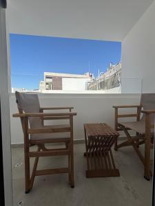 two chairs and a table in front of a window at Tuck Inn in Larnaca